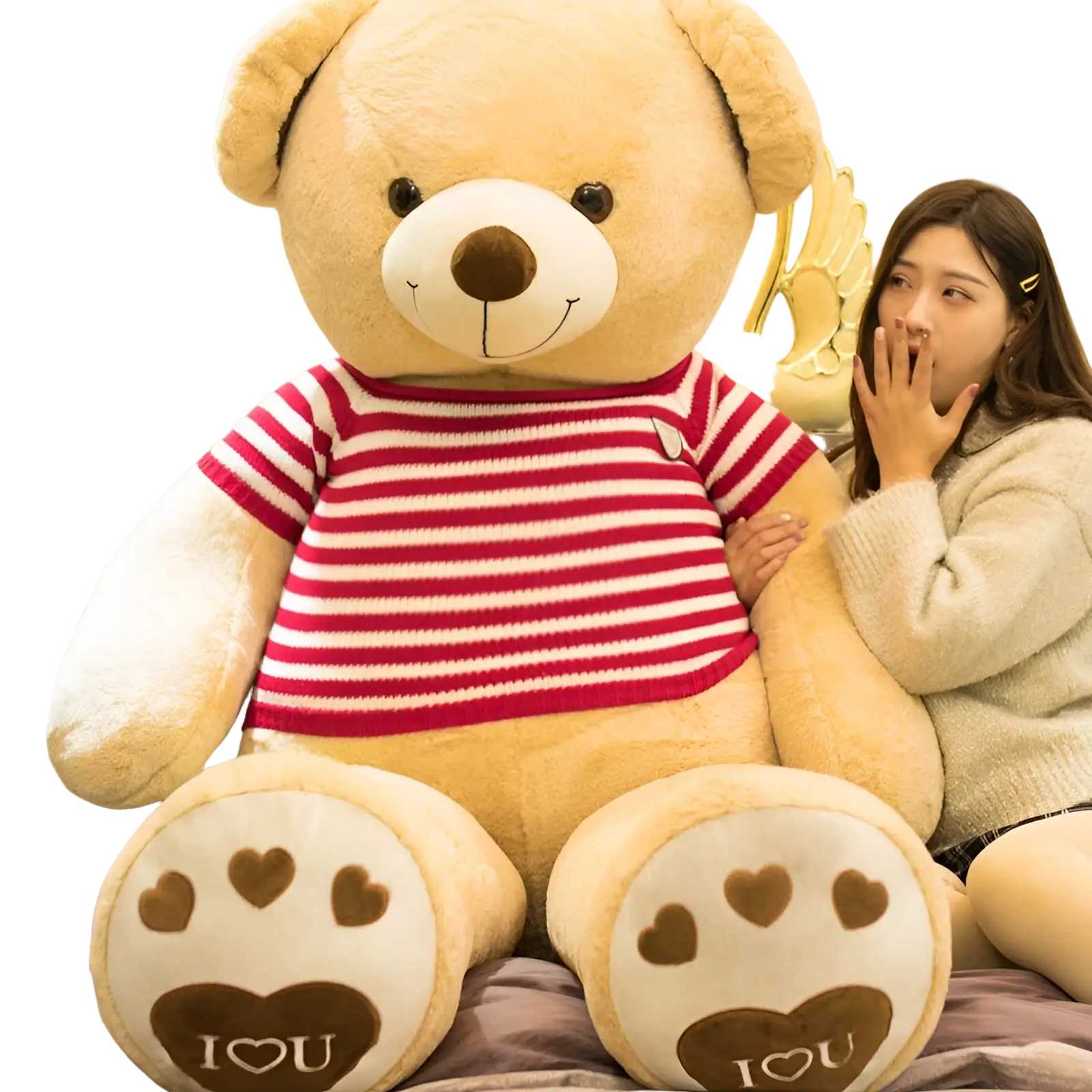 A plush tan giant teddy bear wearing a red and white striped knit heart sweater with heart shaped paw prints