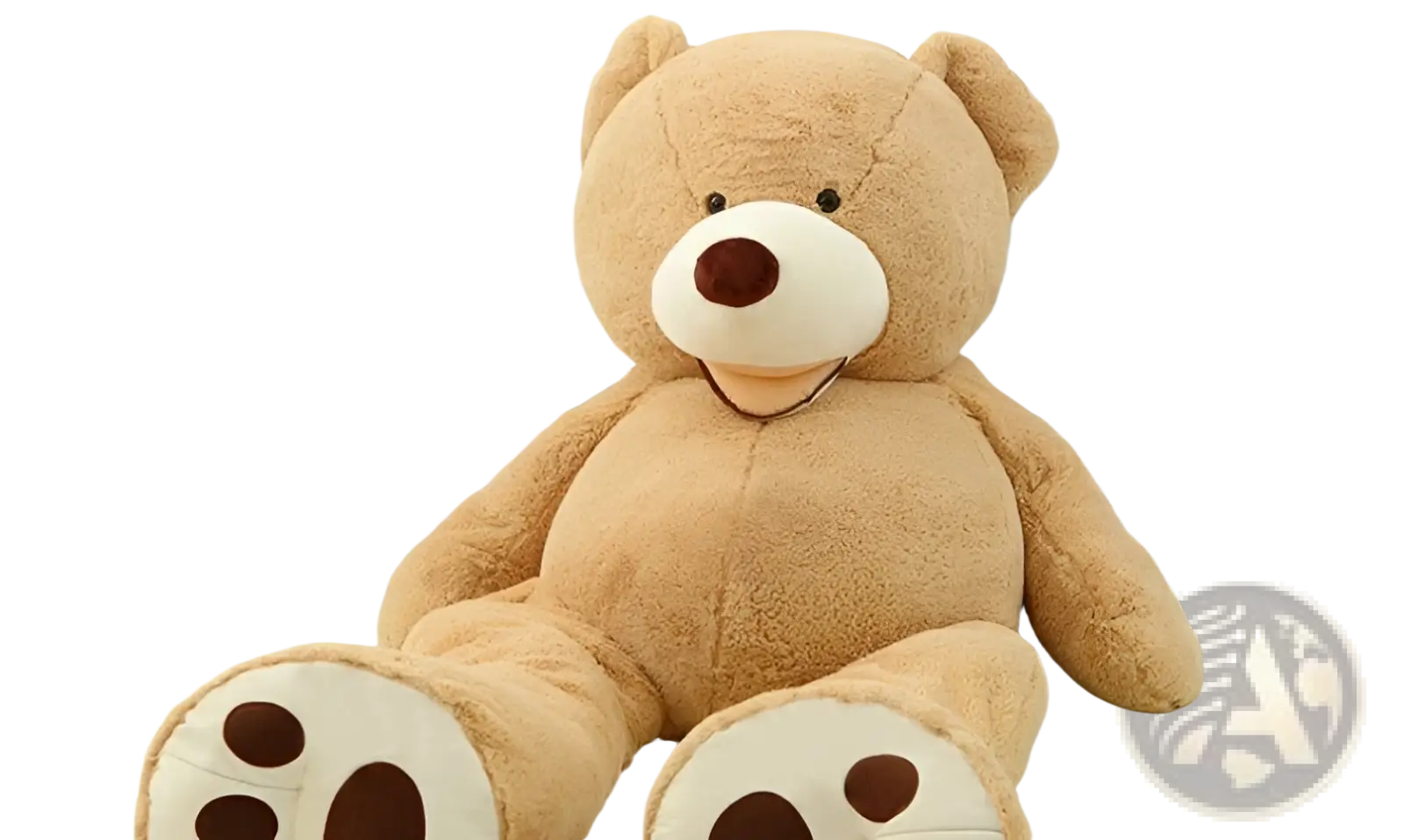A plush tan giant teddy bear plush toy with a white snout and unfilled leather shell sitting on the floor