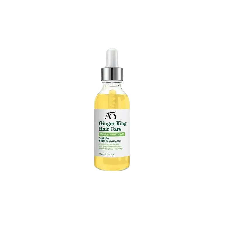 A clear glass bottle with silver dropper containing golden-yellow ginger king hair care scalp oil serum for hair growth