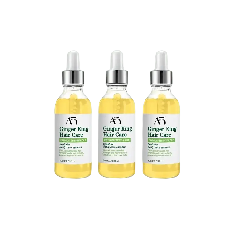 Three transparent glass bottles with silver droppers containing golden-yellow ginger king hair care growth oil serum by wprbregt
