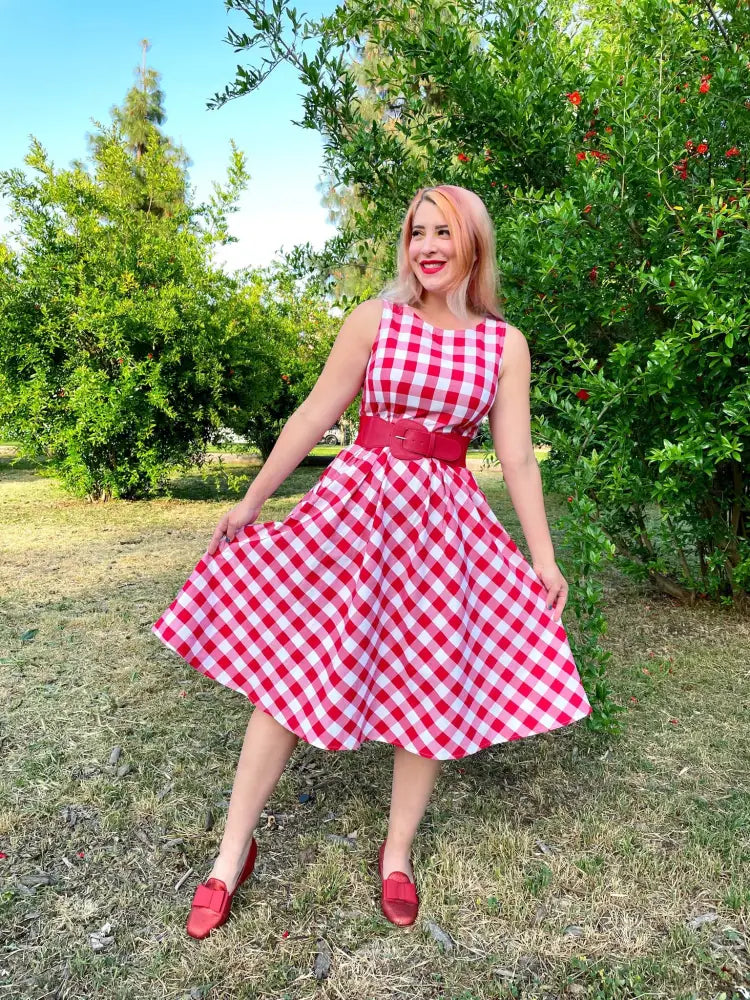 A vibrant red and white gingham check vintage cotton midi swing dress with a fitted waistband