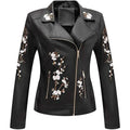 Black faux leather biker jacket with delicate white floral embroidery on sleeves and front for stylish wear