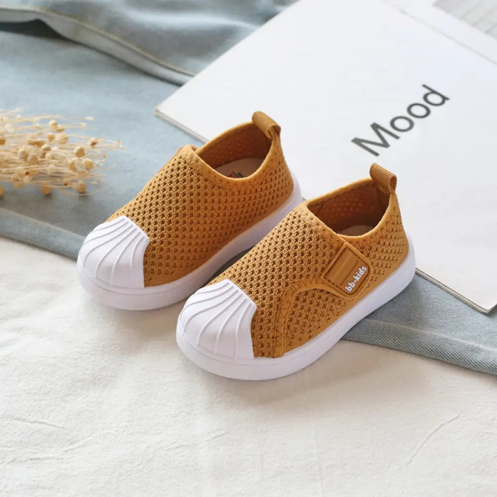 Breathable yellow mesh slip on sneakers for toddlers and kids with white rubber toe caps and brand patch on side