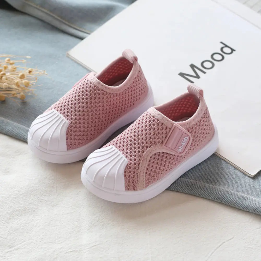 Pink breathable mesh slip on toddler sneakers with white rubber toe caps and velcro strap for kids