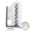 Gray plastic bottle brush with white bristles for cleaning bottles and glasses featuring suction cup sink scrubber