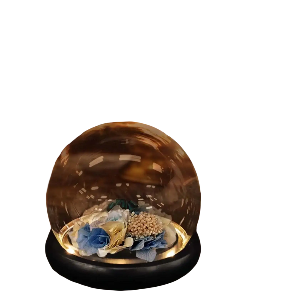 Glass display dome with black base showcasing blue and gold fabric dried floral arrangement inside clear glass