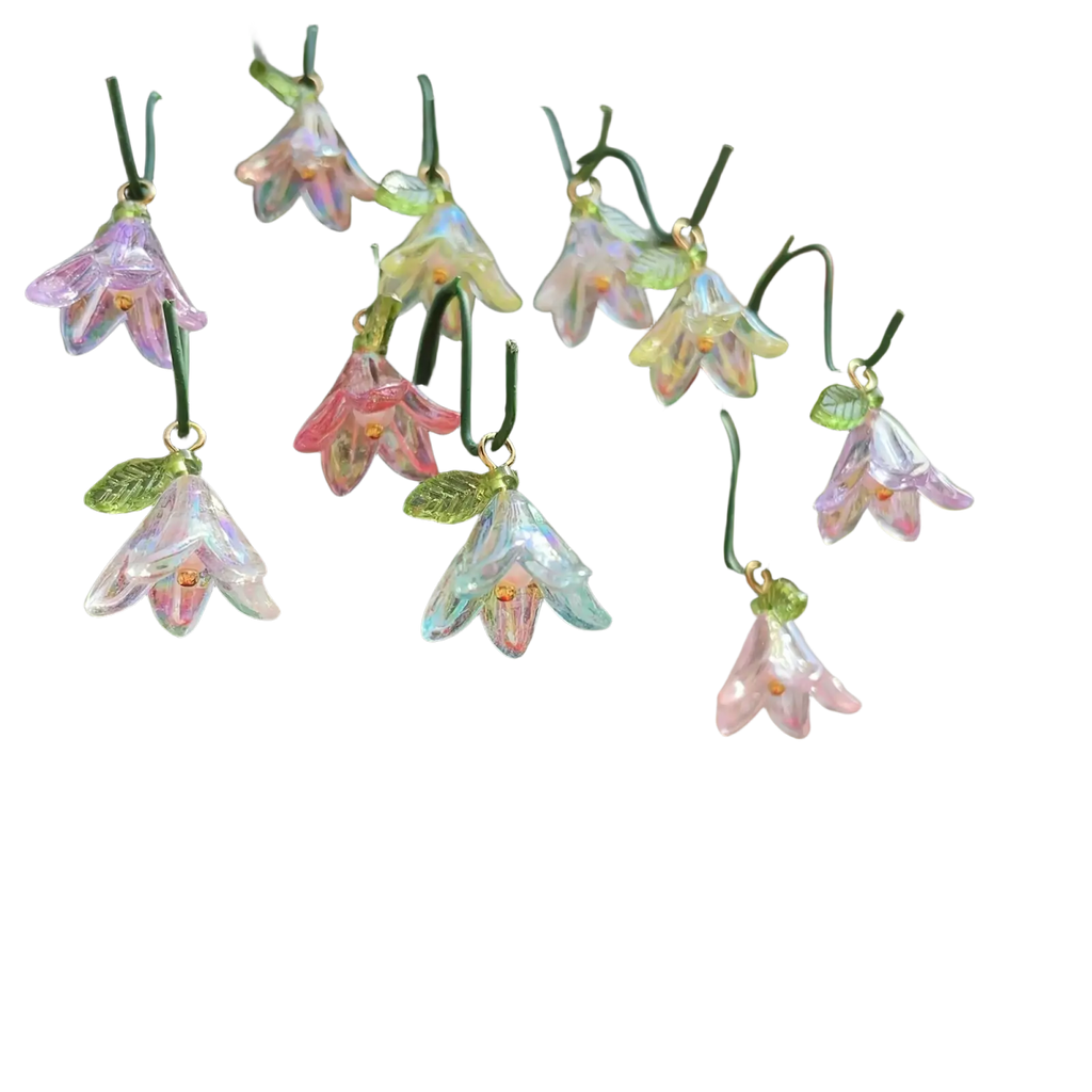 Glass lily garden stakes plant decor featuring delicate translucent pink lavender and pale green glass bellflower ornaments with golden centers