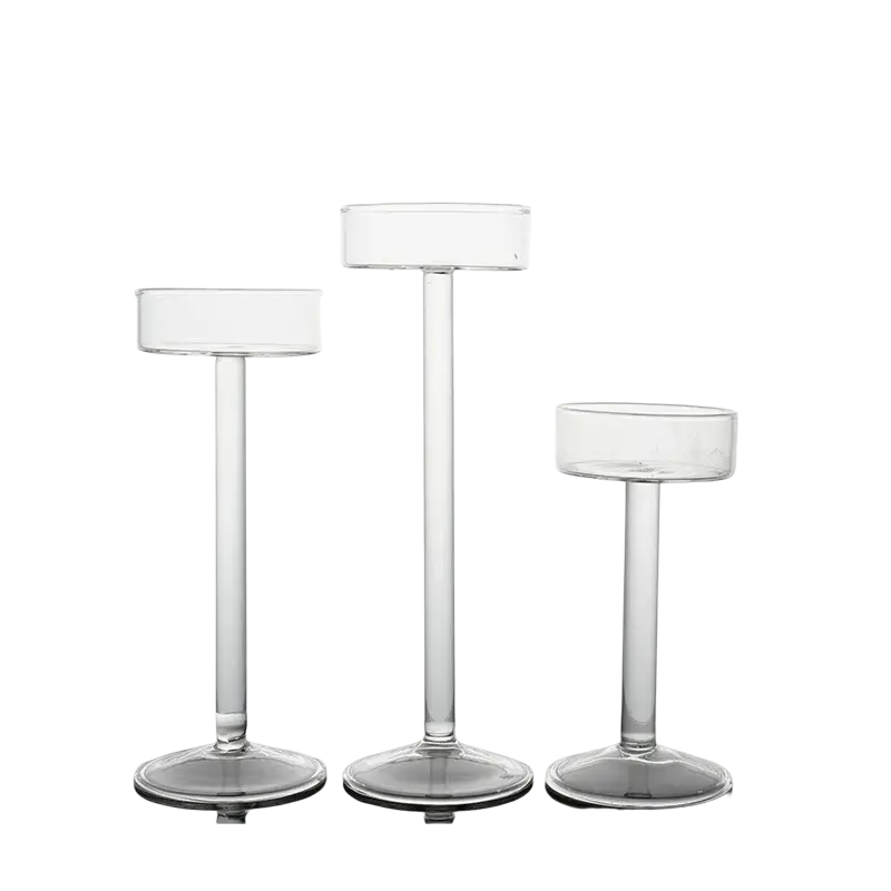 Clear glass pillar candle holder set with slender stems and circular bases for modern table decor