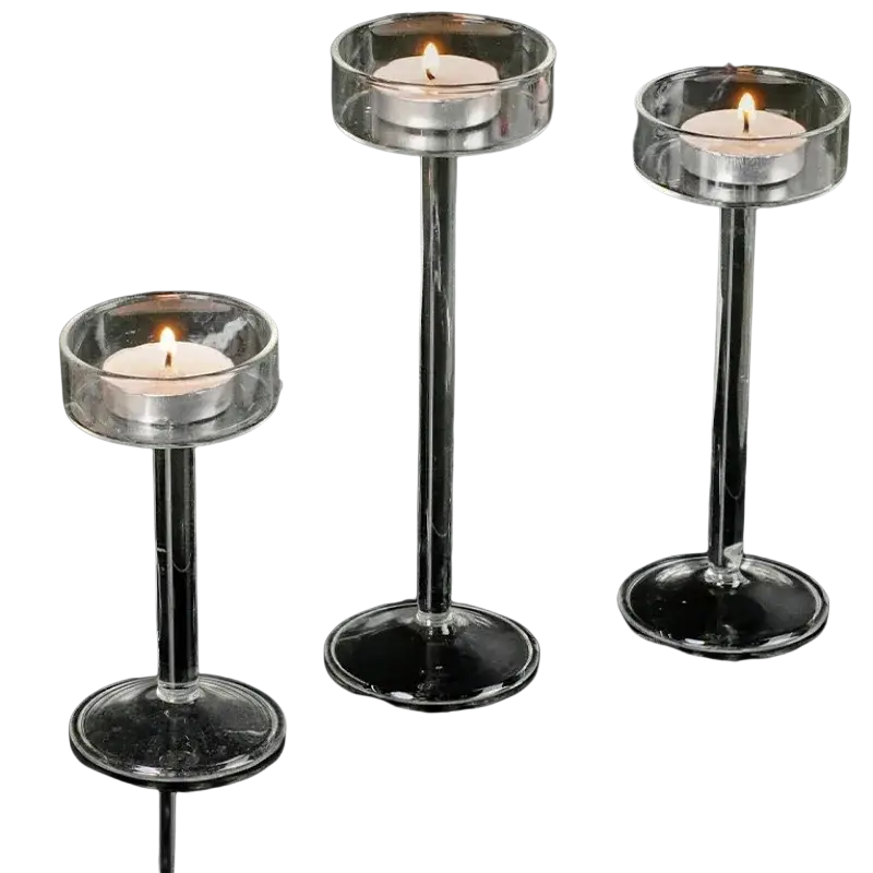 Glass pillar candle holder set featuring clear glass holders with slender stems and circular bases for modern table decor