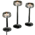 Glass pillar candle holder set featuring clear glass holders with slender stems and circular bases for modern table decor