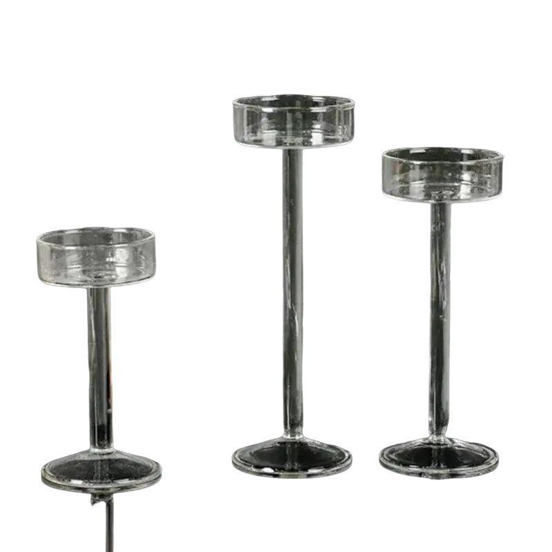Glass pillar candle holder set featuring three clear glass holders with slender stems and circular bases for modern decor