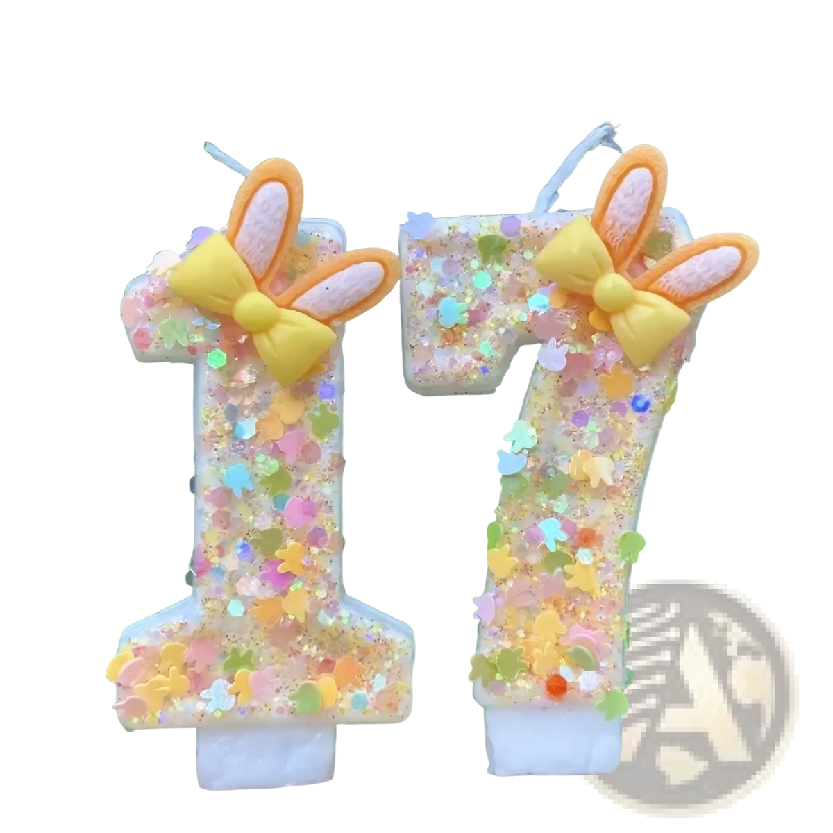 Pastel-colored glitter bunny ear number birthday candles shaped as 1 and 7 with yellow bows