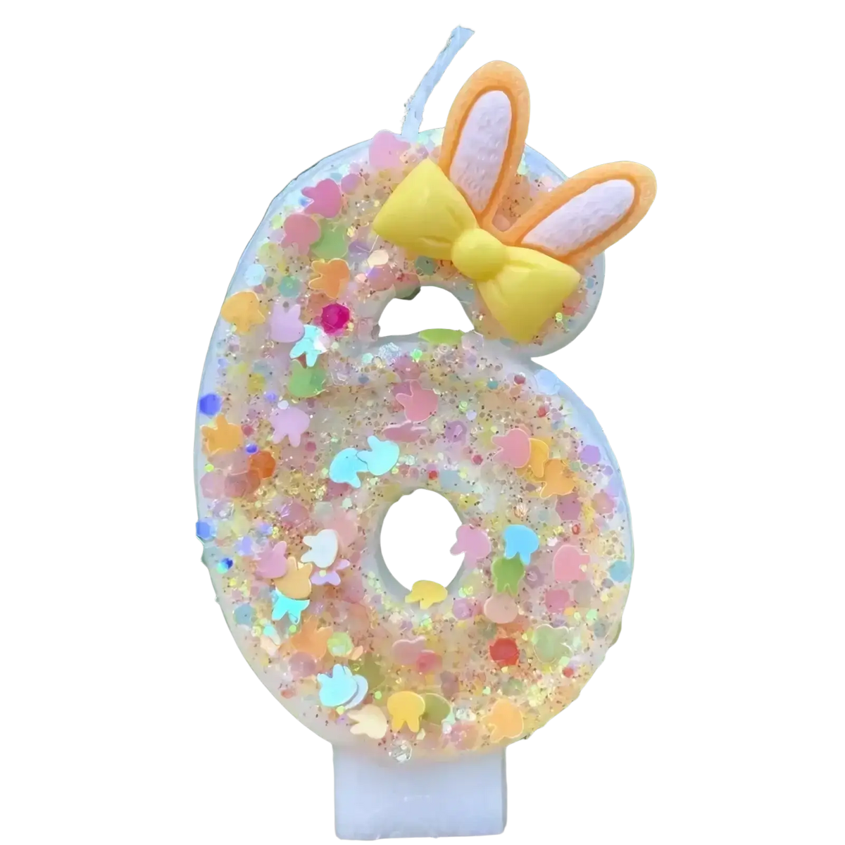 Translucent number six birthday candle with colorful glitter pastel confetti topped with yellow bow and orange bunny ears