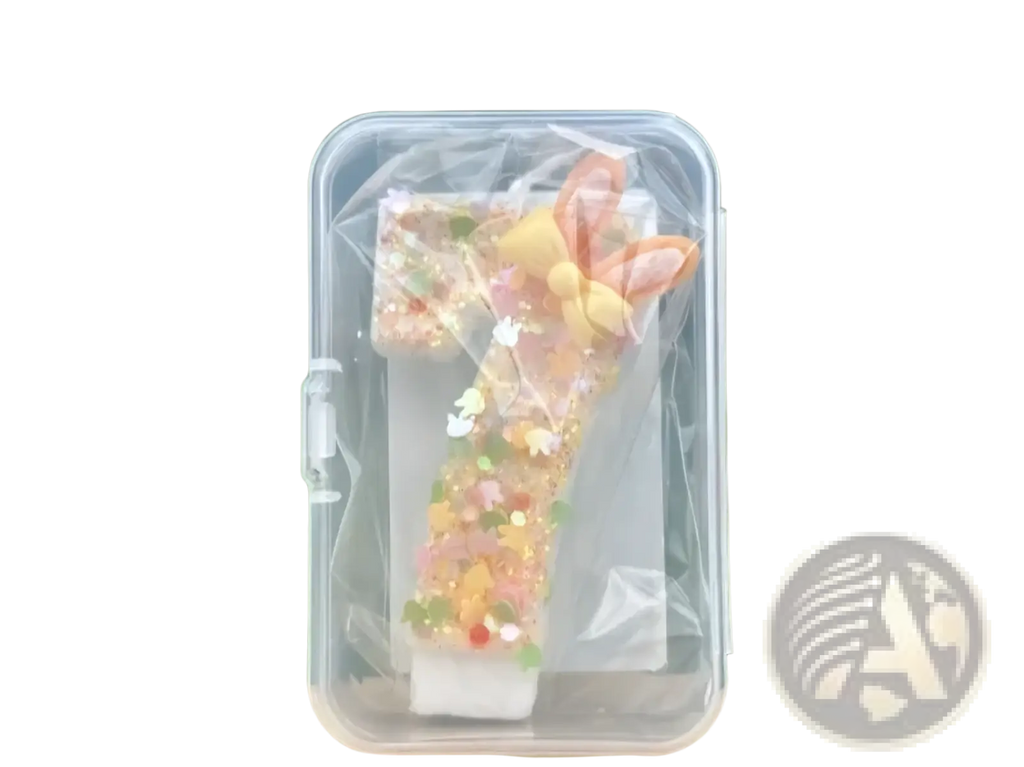 Glitter bunny ear number birthday candle translucent with pastel pink and yellow ears and glitter inside