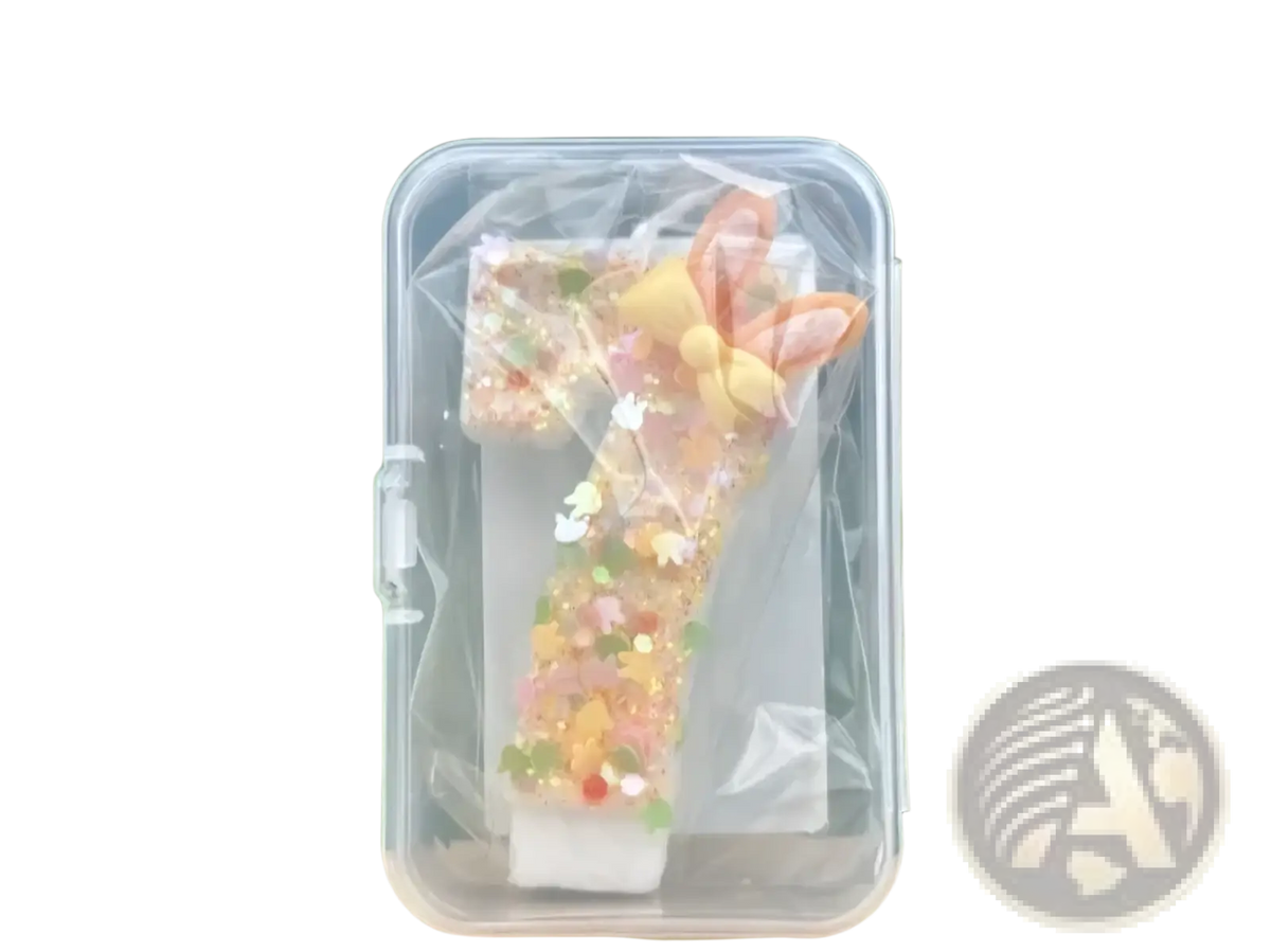 Glitter bunny ear number birthday candle translucent with pastel pink and yellow ears and glitter inside