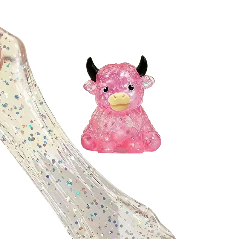 Pink translucent plastic highland cow slow rising squishy toy with black horns and yellow nose glitter design
