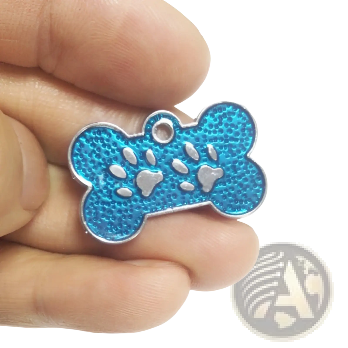 A vibrant blue glitter paw print metal dog tag with a textured bone shape and silver paw print designs