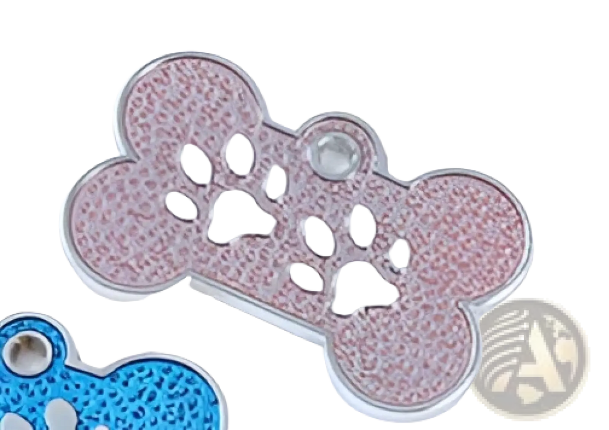 Pink glittery metal bone-shaped dog tag with silver paw print cutouts for pet identification purposes