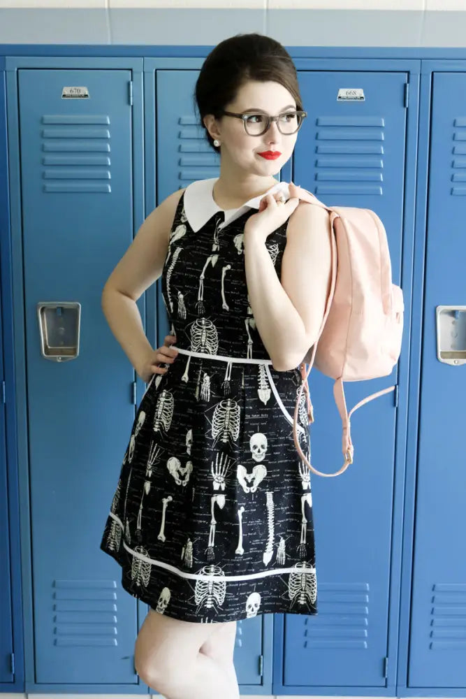 Black sleeveless glow in the dark skeleton print retro a-line dress with white collar and flared skirt with trim hem