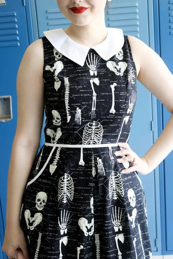 Black sleeveless glow in the dark skeleton print retro a-line dress with white peter pan collar and skeletal anatomy design
