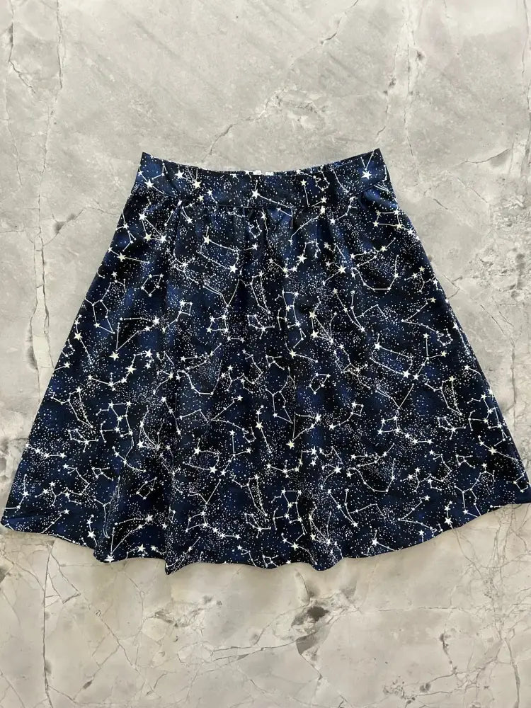 A navy blue cotton a-line skirt with a white glow in the dark constellation pattern