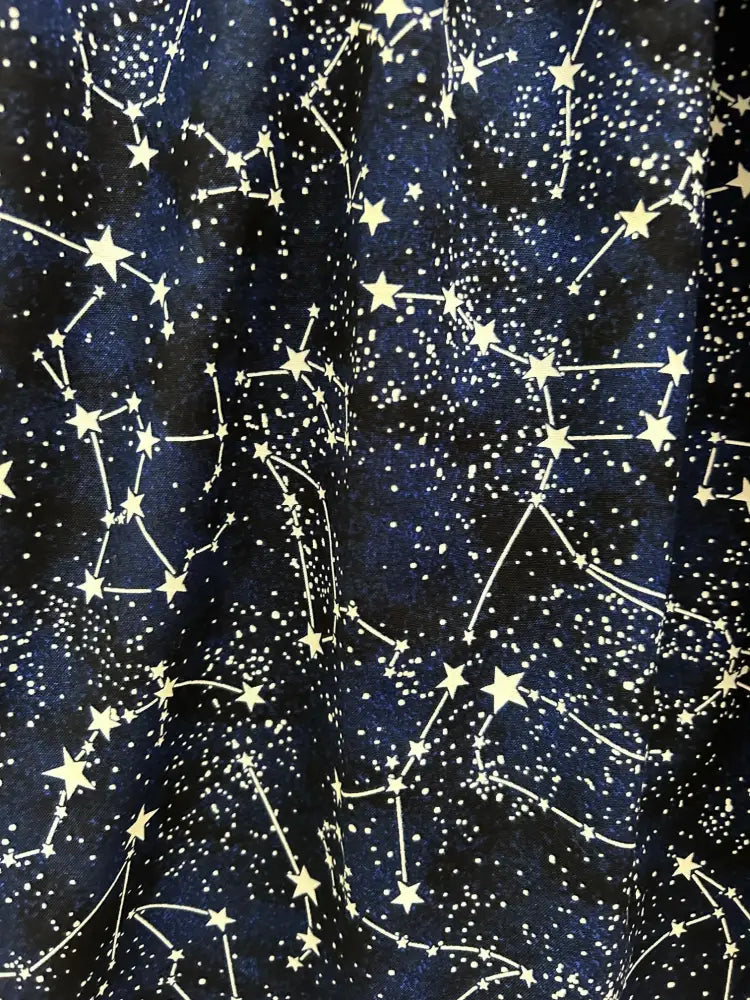 Dark blue glow in the dark constellation midi dress with pockets featuring white and gold stars connected by lines