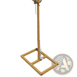 A golden metal stand with a square base and coiled rope top part of glowing butterfly wings hanging wedding stage light