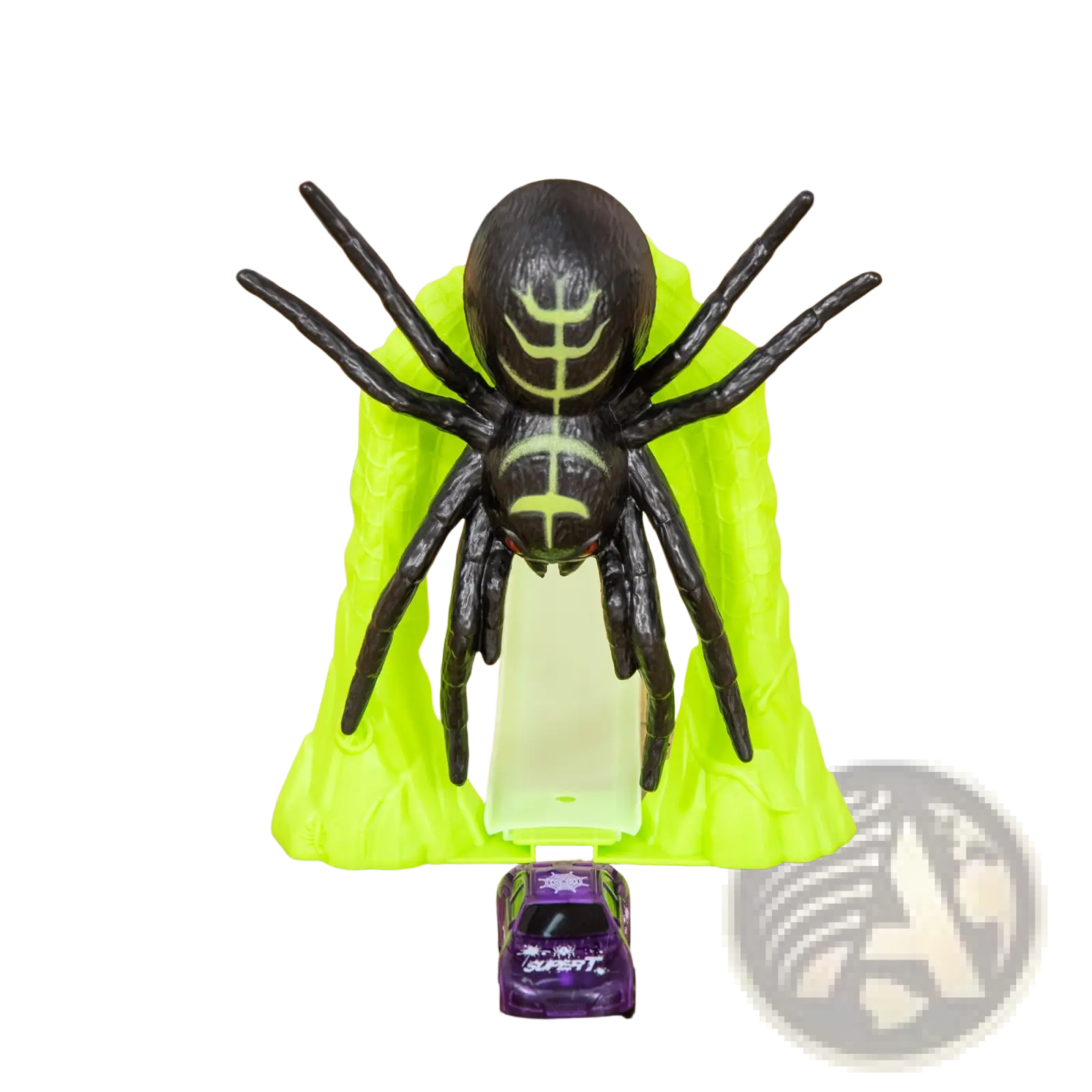 Black plastic spider with glowing green markings and red eyes on lime-green base from glowing race track toy spider loop playset