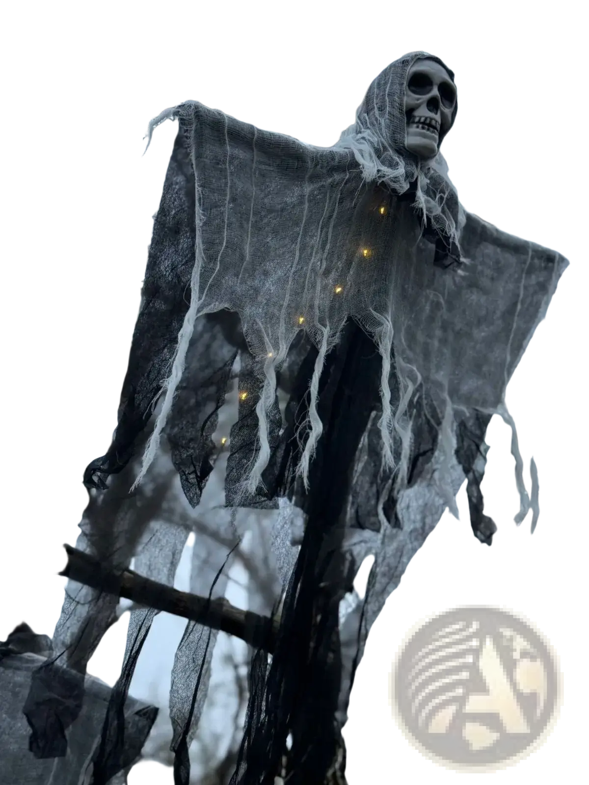A glowing skull hanging Halloween ghost decoration with a gray skeletal figure draped in tattered black and white mesh