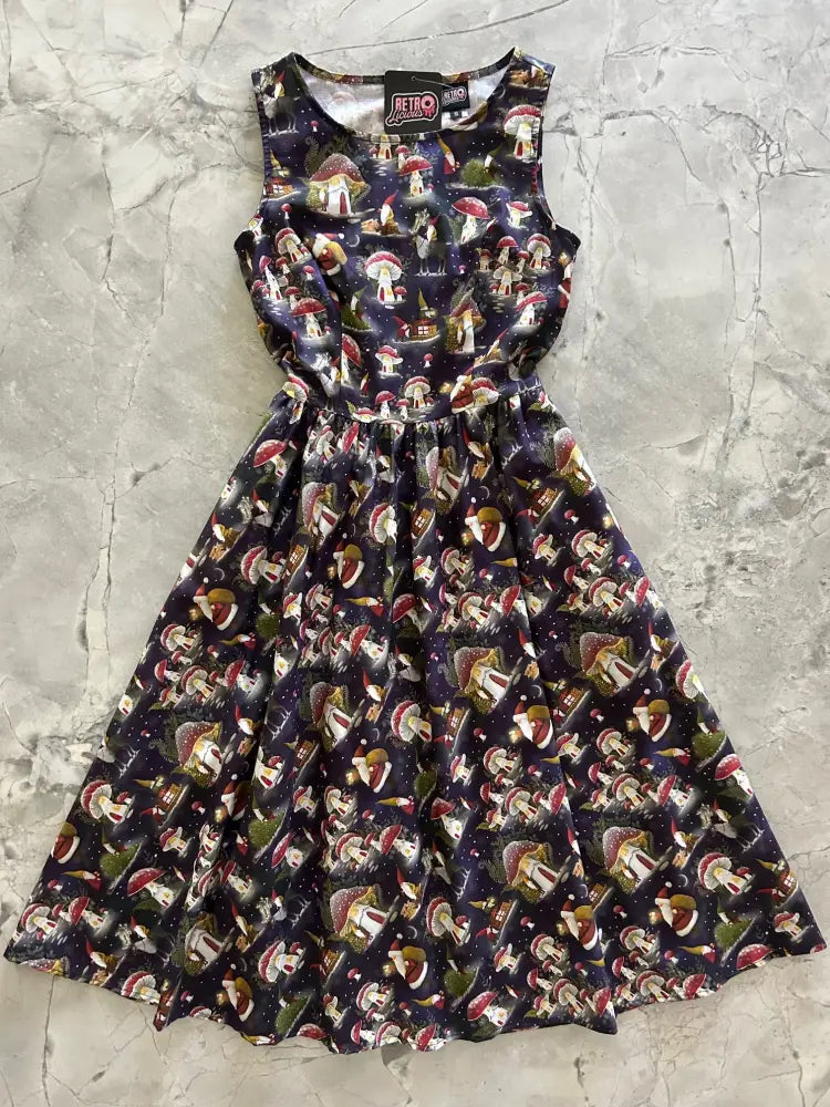 A sleeveless dark navy cotton midi dress with a whimsical gnome and mushroom print against a starry night sky