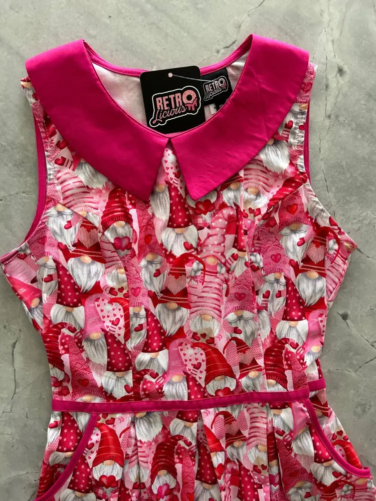 Retro gnomes pink cotton A-line dress with pockets featuring playful red and white gnome pattern and satin accents