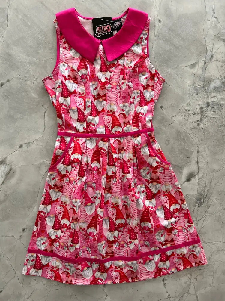 Sleeveless retro gnomes pink cotton a-line dress with bold gnome print and matching bright pink collar belt and hem