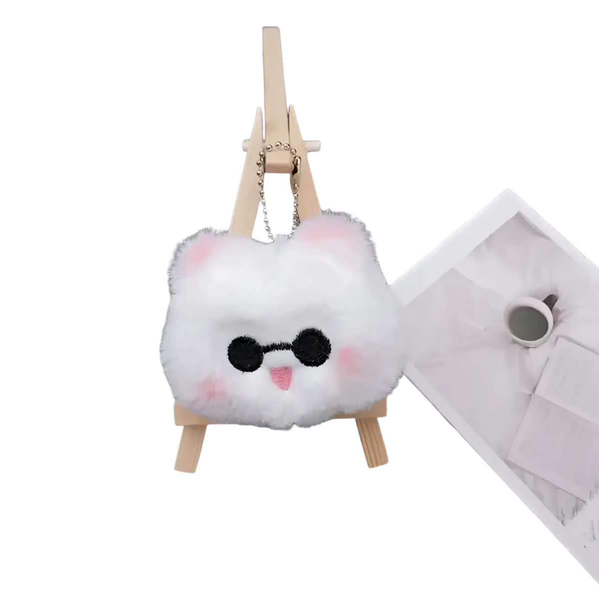 A fluffy white plush Gojo and Geto cat anime keychain with pink ears black eyes and a small pink tongue