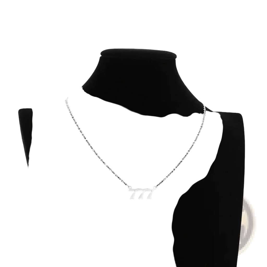 Silver chain necklace with minimalist gold pendant featuring number 777 in modern font for angel number 7 necklace