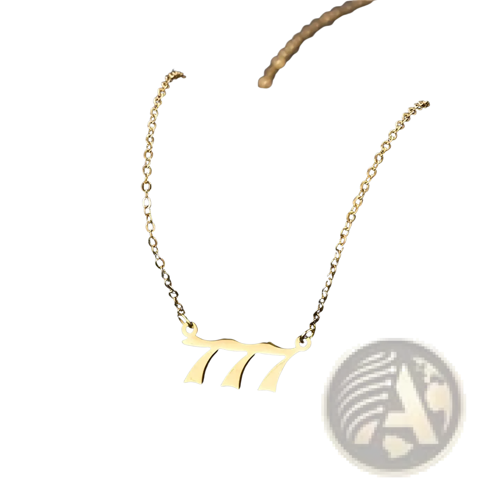 Gold angel number 7 necklace with a gold-toned minimalist pendant shaped like number 777 in elegant cursive font