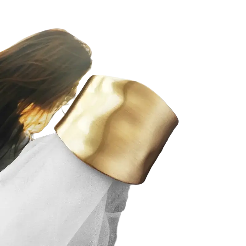 Gold asymmetric wide bangle bracelet featuring a gold-toned textured hammered finish and wide cuff design