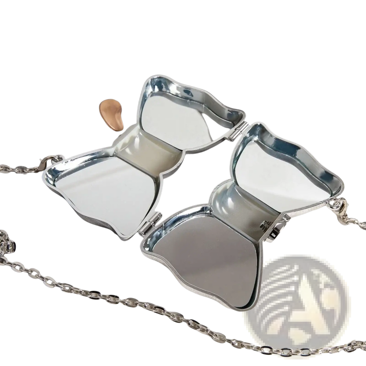 Silver butterfly-shaped compact mirror with reflective surfaces and chain strap shown with gold bow metal clutch crossbody bag