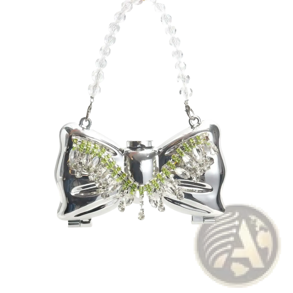 Gold bow metal clutch crossbody bag in shiny silver with green and clear crystal accents and a beaded chain strap