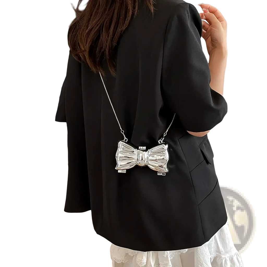 Silver metallic bow-shaped metal clutch crossbody bag with chain strap for elegant evening use
