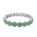 Silver-toned stretch bangle style bracelet with circular motifs featuring green and clear crystals in zinc alloy
