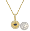 Gold compass pendant necklace with diamond-encrusted face featuring blue and clear gemstone directional markings