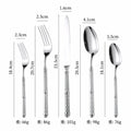 Set of five gold stainless steel cutlery pieces with textured patterned handles for elegant tableware use