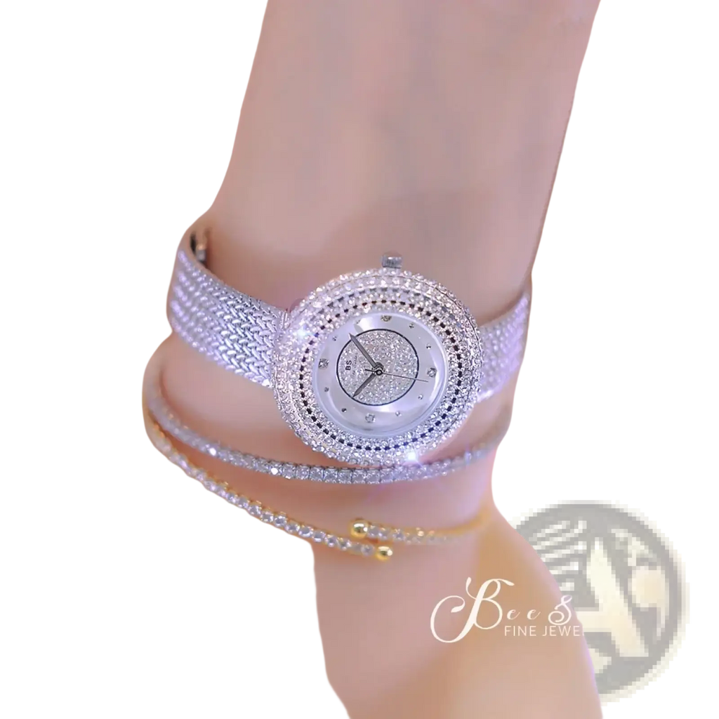 A sparkling silver luxury women watch with diamond-encrusted bezel and woven band featuring a glittering face