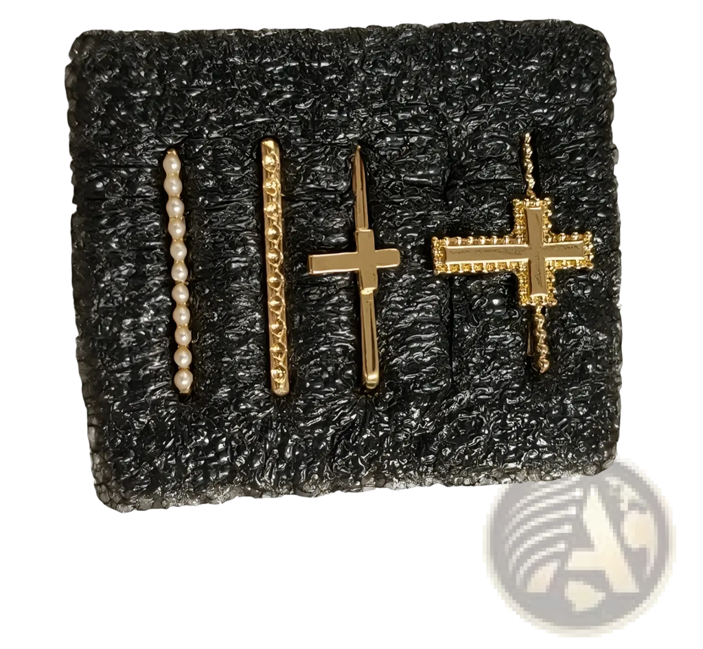 Set of four gold-toned cross and beaded bar earrings on black foam backing from gold embellished silicone strap ring set