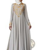 A flowing beige cotton abaya dress with intricate gold floral embroidery along the neckline and cuffs