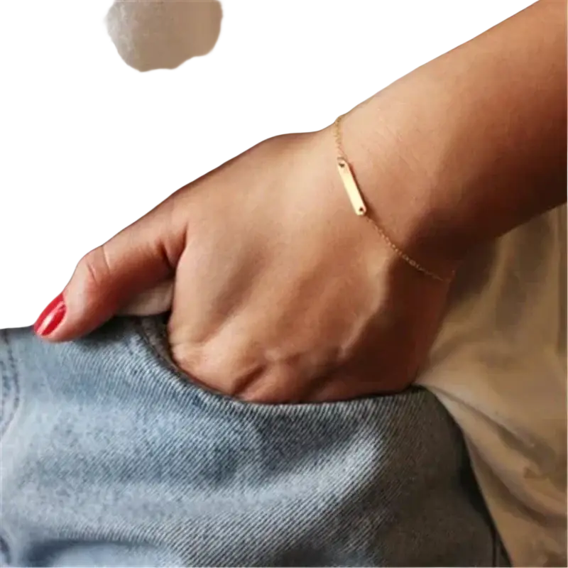 A gold filled bar charm bracelet with a slender chain and tarnish resistant mechanically bonded finish