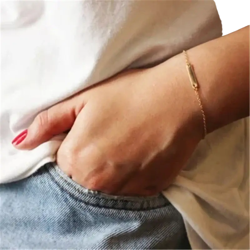 A delicate gold filled bar charm bracelet with a slender chain and tarnish resistant mechanically bonded pendant