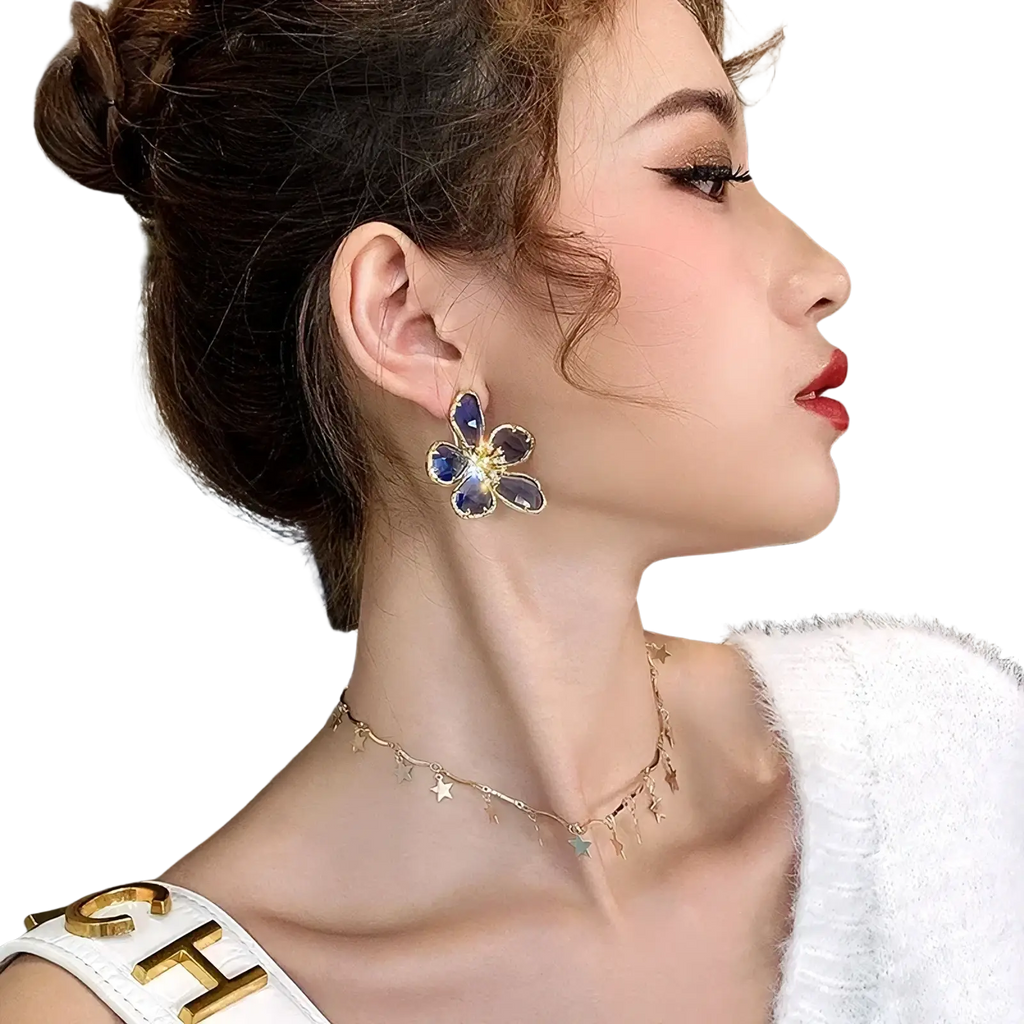 Gold flower crystal stud earrings featuring deep blue gemstone petals set in gold metal