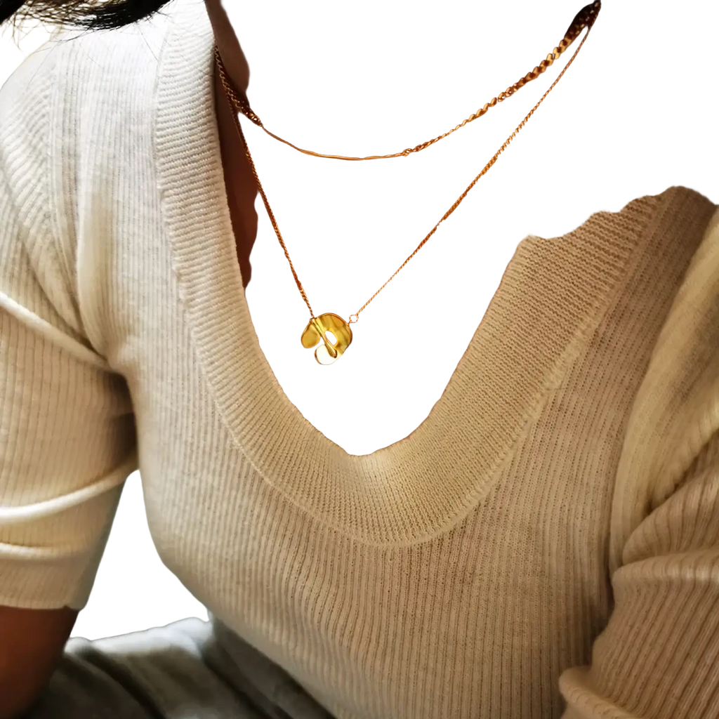 Gold geometric layered pendant necklace for women featuring a gold-toned delicate chain and a small shiny musical note pendant