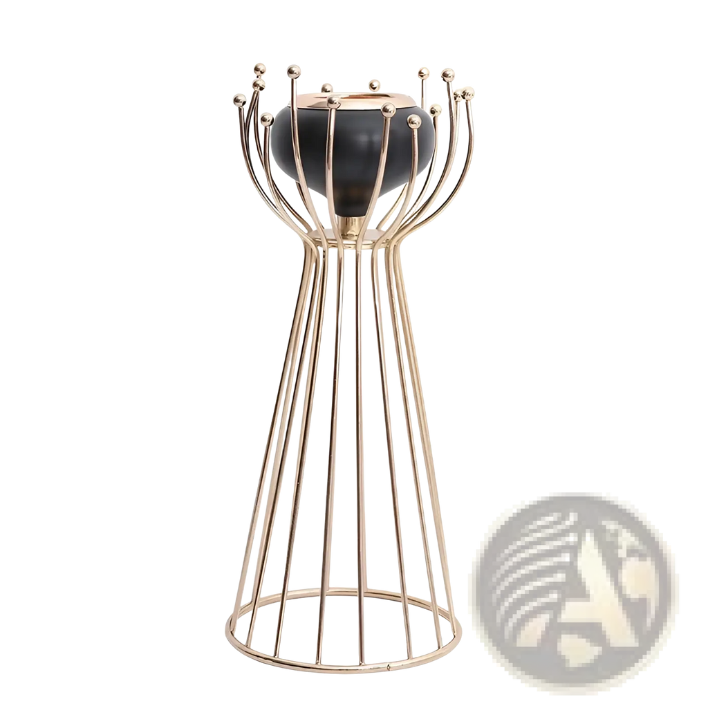 Gold geometric wire cage candle holder with gold-toned metal and sleek black ceramic base with decorative spheres